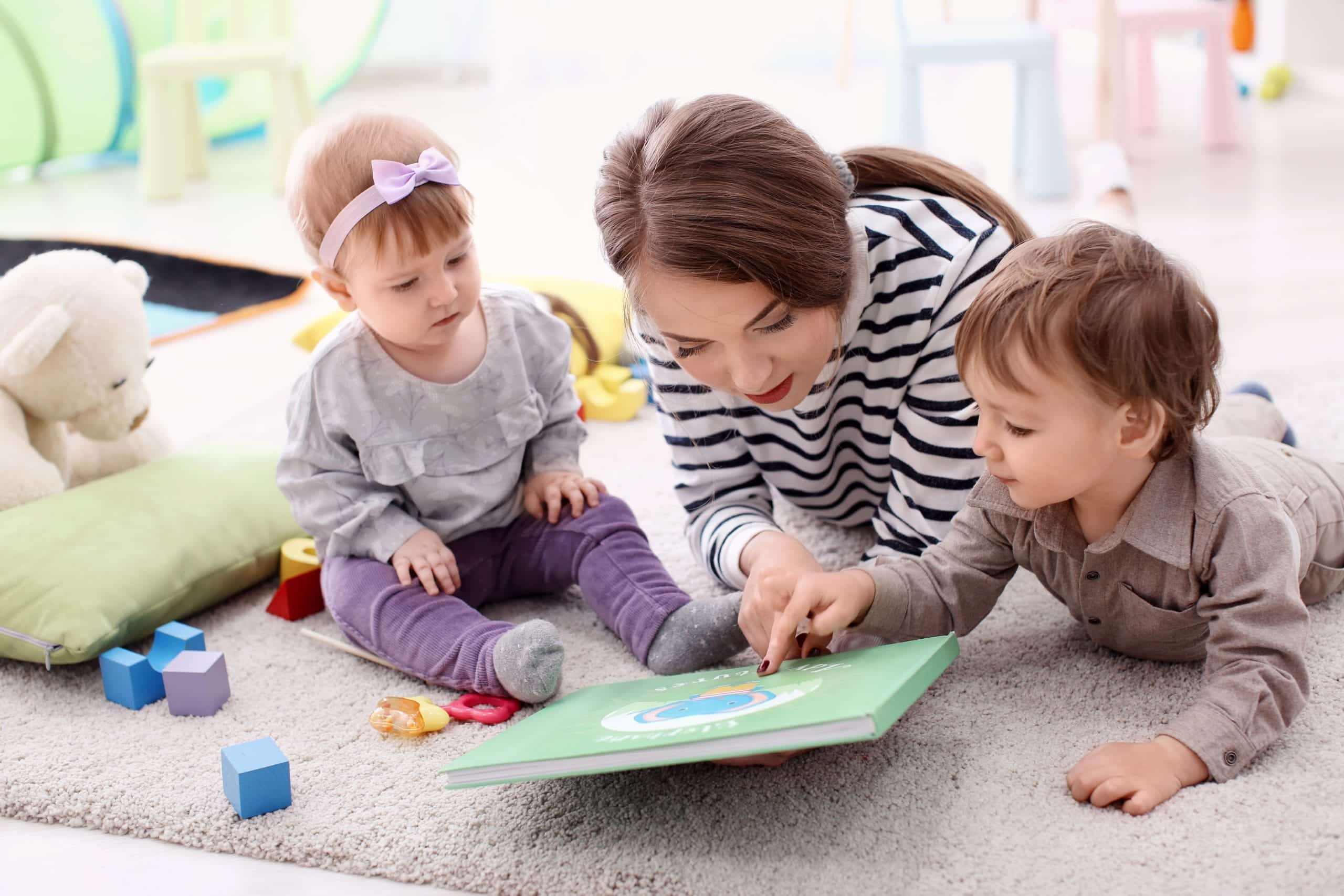 Professional rota nanny engaging twin toddlers in a modern Miami Beach home